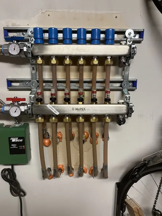 Plumber performing Water Heater Repair at a residential property in Lloyd Harbor